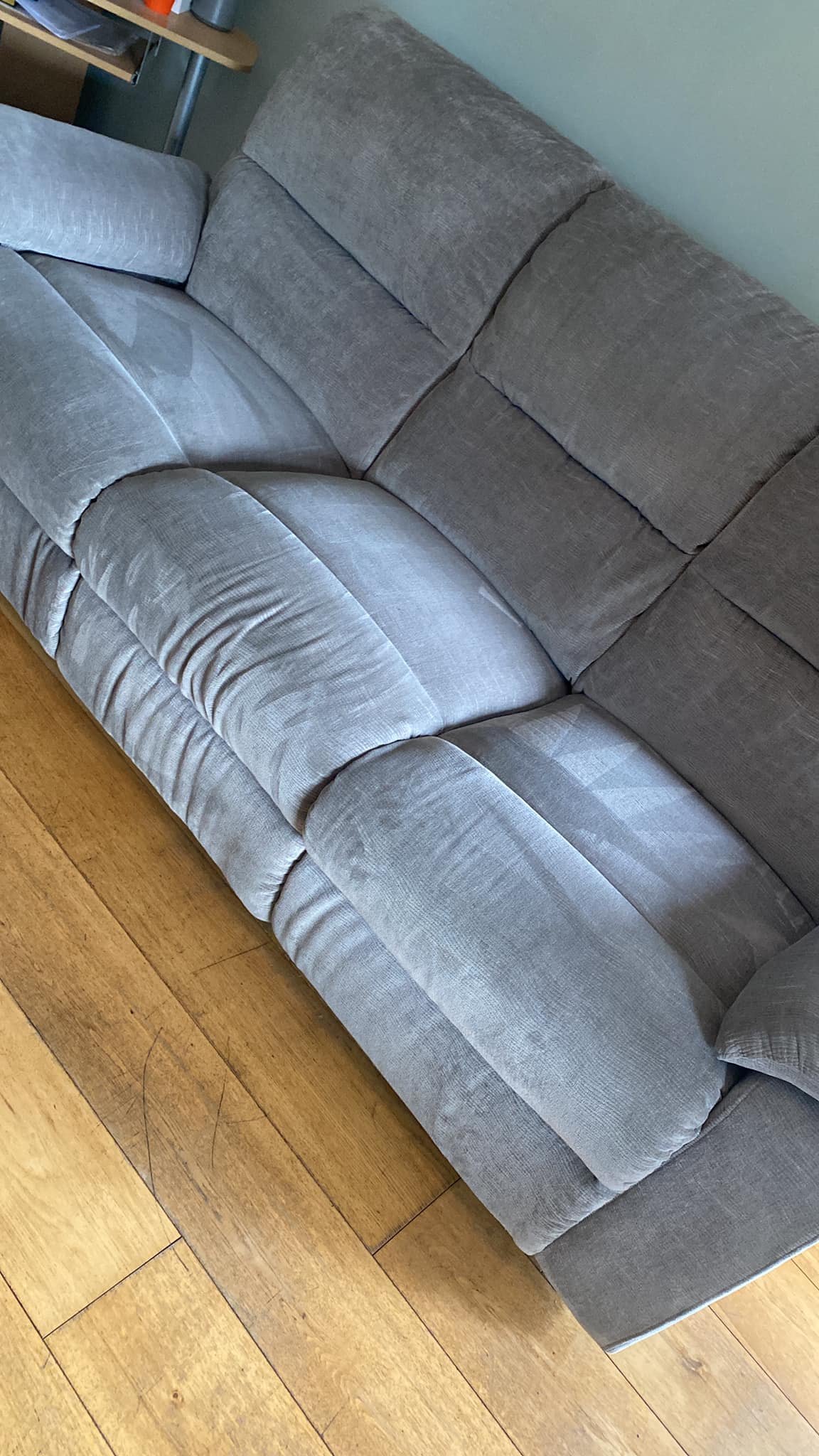 Dirty sofa being cleaned by a professional cleaner